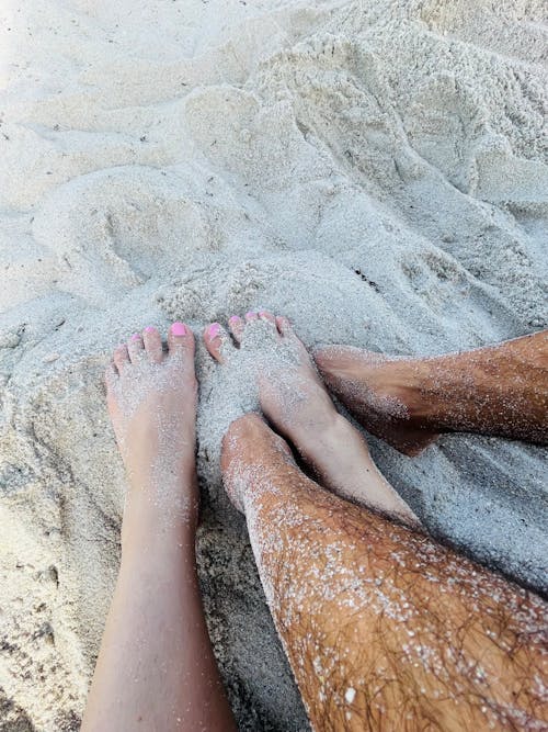 Couple Legs in Sand on Beach