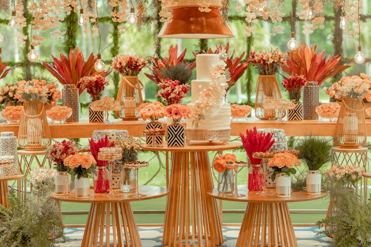 Flowers Around Decorated Tables With Cake