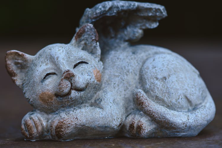 A Close-Up Shot Of A Sculpture Of A Cat With Wings