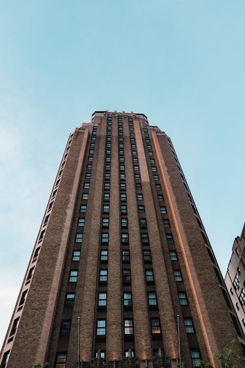 Low Angle Shot of Brown Concrete Building Under Clear Blue Sky 