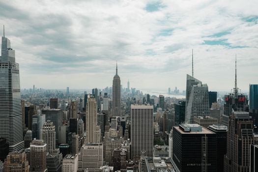 A breathtaking view of New York City's skyline featuring the iconic Empire State Building on a cloudy day.