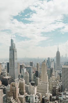 Aerial view of Manhattan's iconic skyline featuring towering skyscrapers and the Empire State Building.