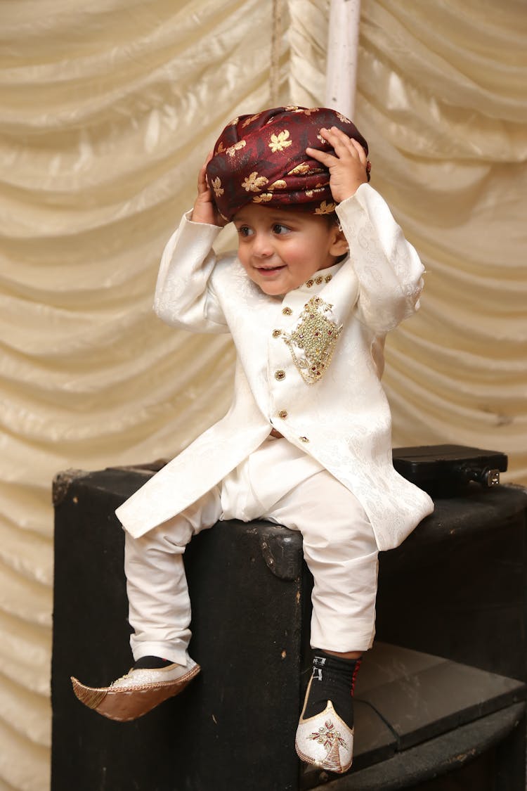 A  Boy In White Suit And A Turban