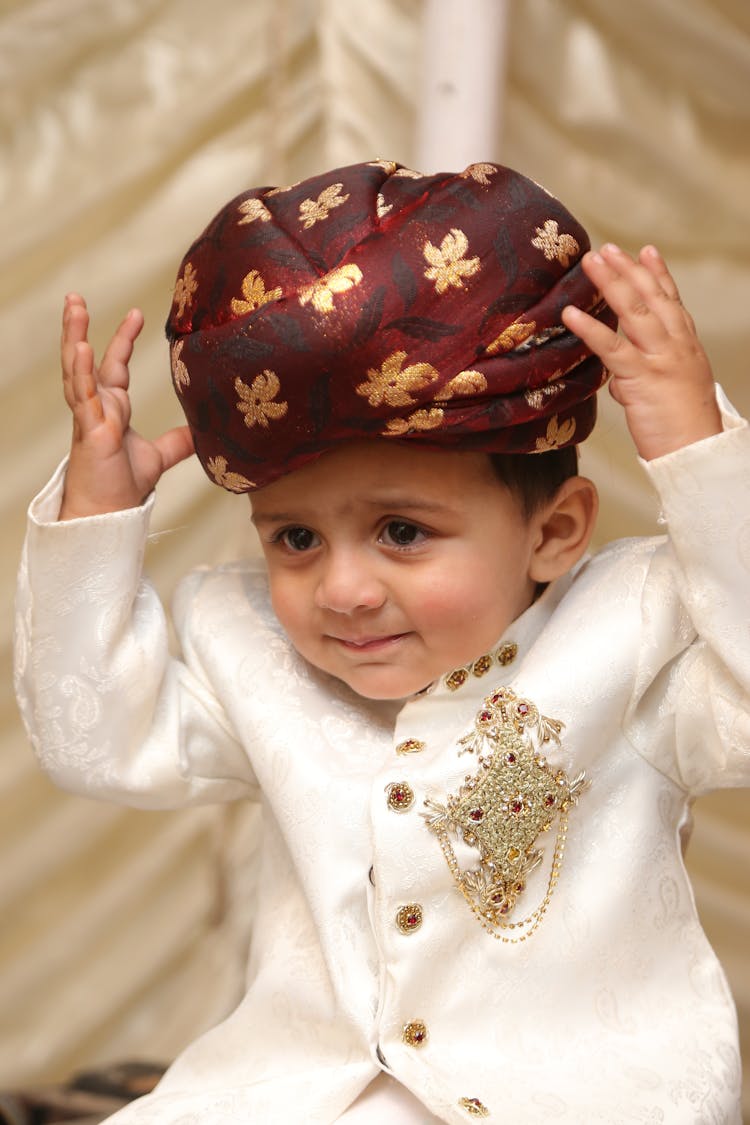A Cute Boy Wearing A Turban And White Suit