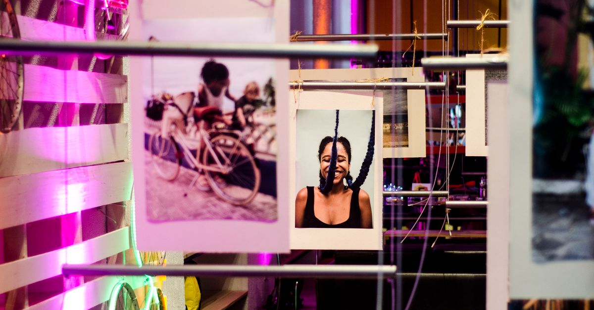 Colorful indoor gallery capturing vibrant photographs on display, exuding modern artistic vibe.