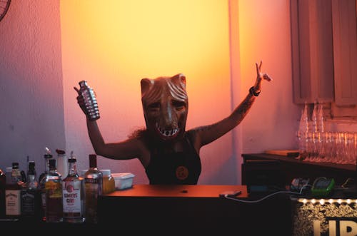 Free Person Wearing Mask Holding Cocktail Shaker Stock Photo