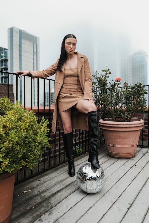 Woman in Brown Suit Posing on Terrace