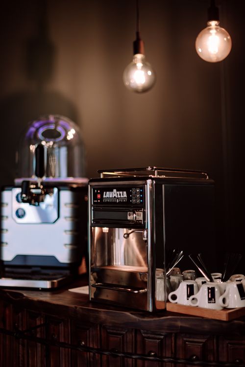 Free Stylish espresso machine and coffee setup in a chic Geneva café interior. Stock Photo