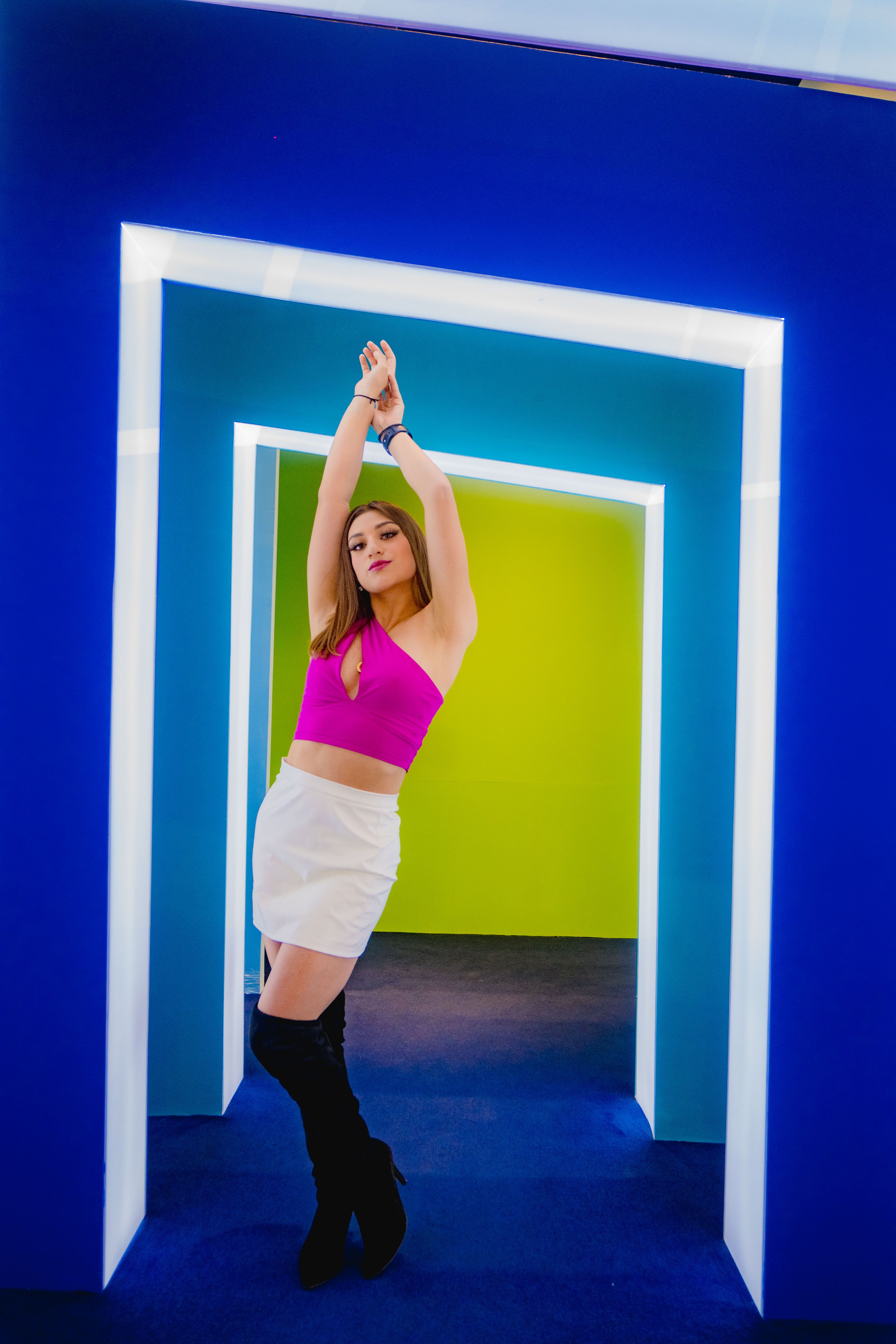 A Woman Posing While Raising Hands · Free Stock Photo