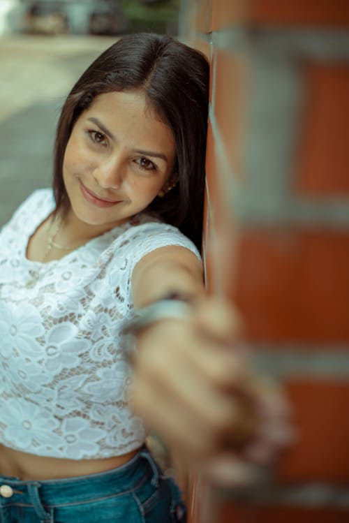 Woman in White Lace Top Leaning on the Wall 