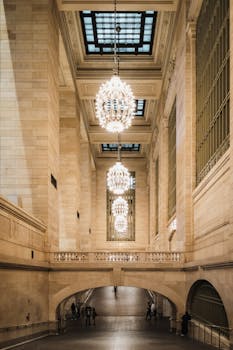 Majestic hallway with chandeliers in Grand Central Terminal, New York City, showcasing architectural grandeur.