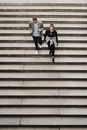 Girl in Pink Jacket Sitting on Brown Concrete Stairs