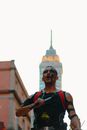 Man in Costume and Makeup with Microphone in a City