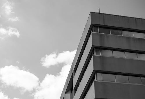 Grayscale Photo of a Building under the Cloudy Sky