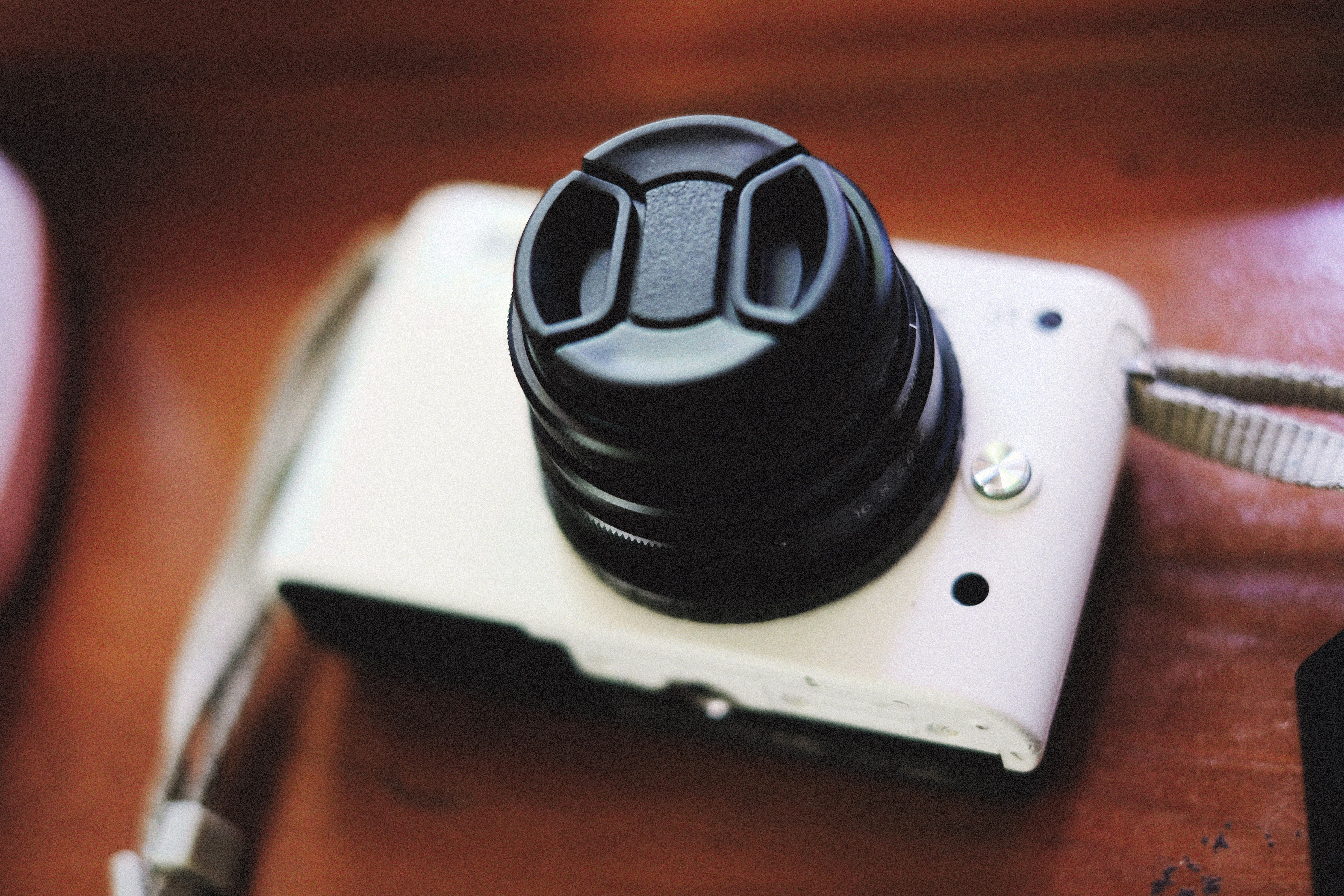 Close-Up Photo of a Camera with a Lens Cover · Free Stock Photo
