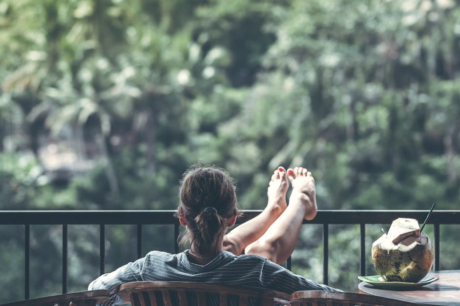 Woman Sitting on Brown Wooden Chair Beside Coconut