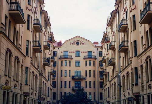 Free Aesthetic view of historic apartment buildings with decorative balconies and glass windows. Stock Photo