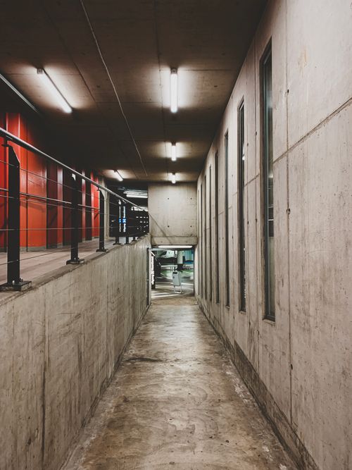 Free A modern concrete hallway in Alkmaar, featuring industrial design elements and fluorescent lighting. Stock Photo