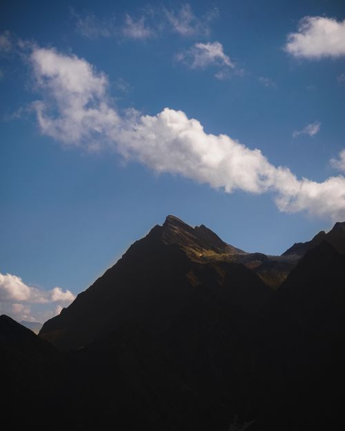 Free Majestic mountain silhouette against a vibrant blue sky in Manali, Himachal Pradesh, India. Stock Photo