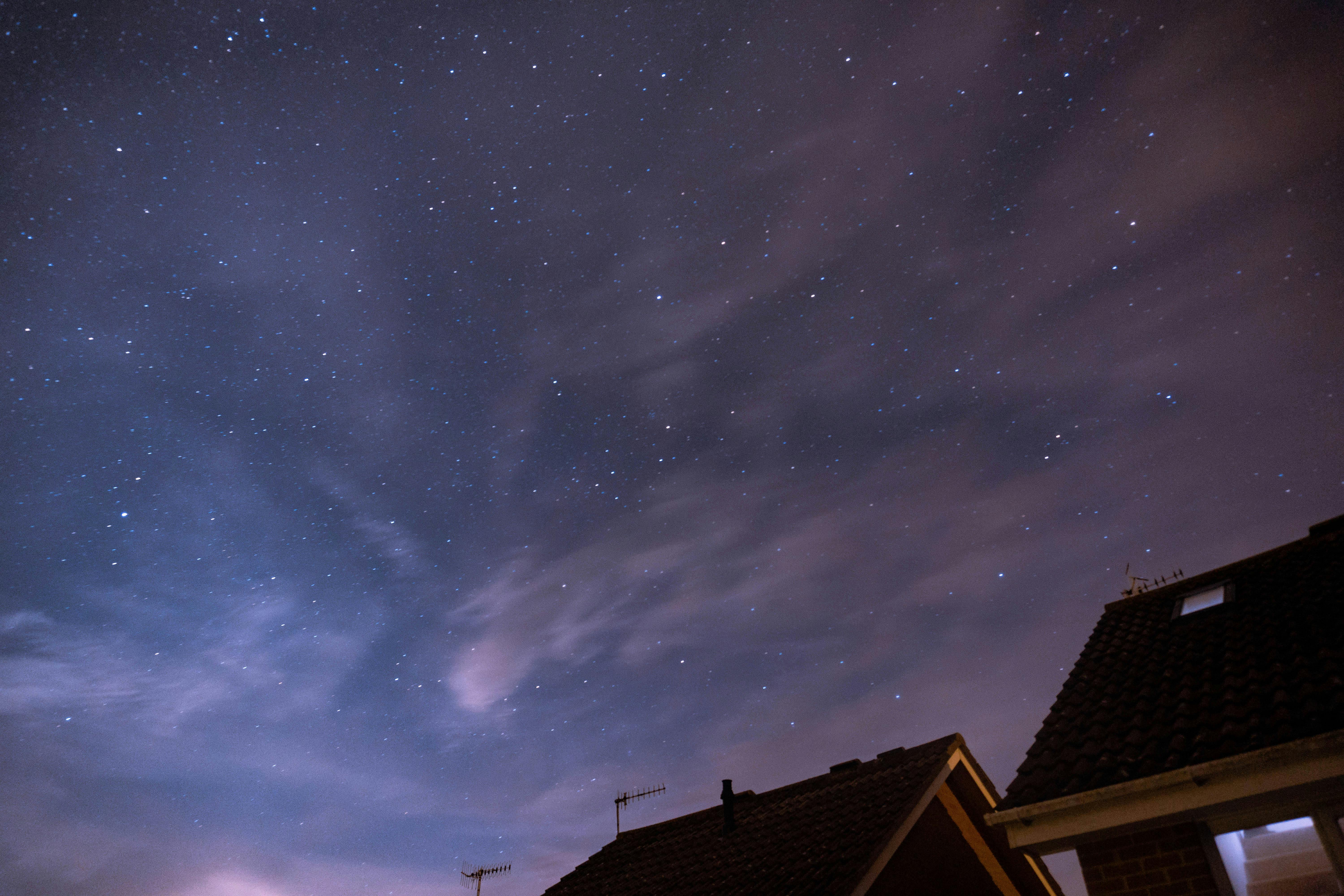 Grey Roofs Under Blue Starry Sky · Free Stock Photo