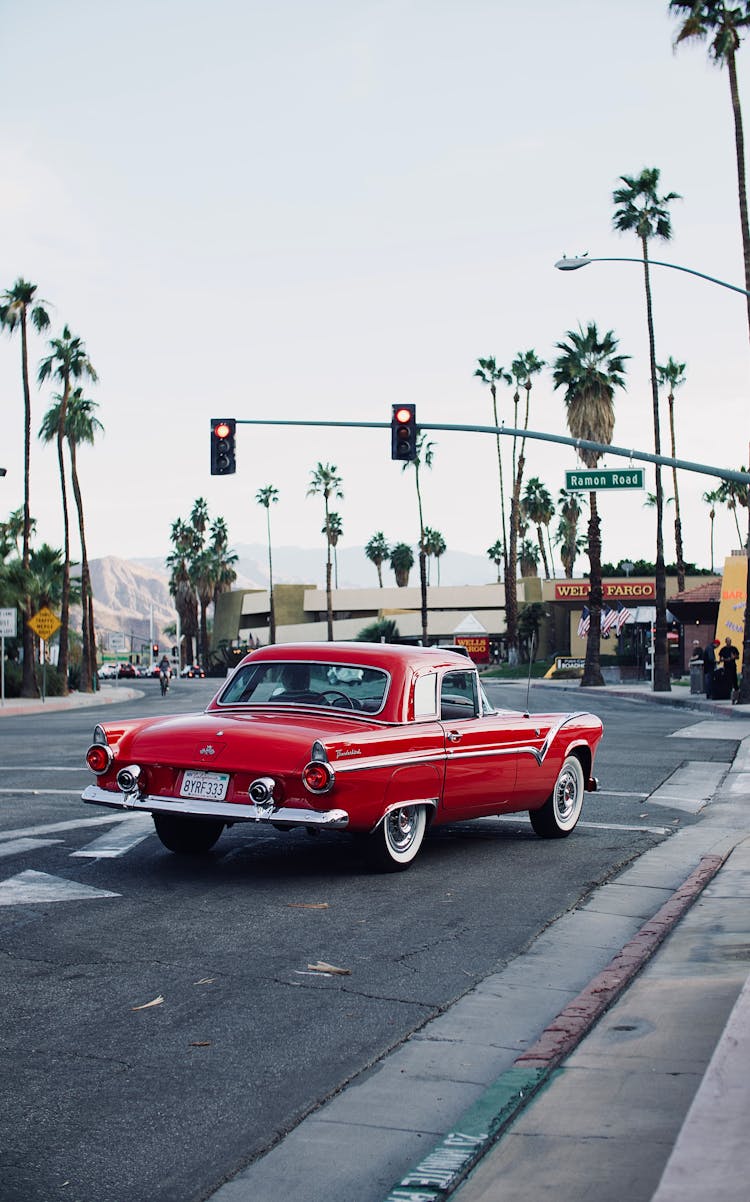 Red Vintage Car On Street And Palm Trees