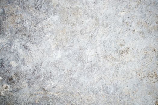 A detailed view of a textured concrete wall showing weathered and worn patterns.