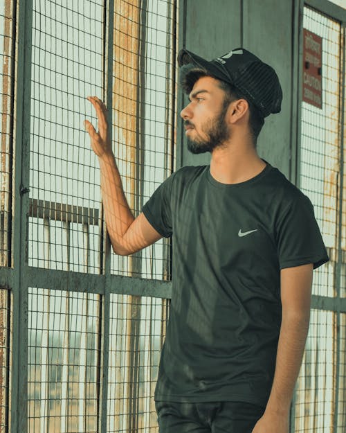 Free Man in Black Crew Neck Shirt and a Cap  Stock Photo