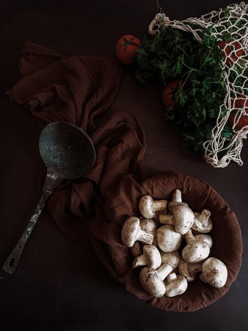 Free Top view of fresh mushrooms and vegetables with rustic props, perfect for food photography. Stock Photo