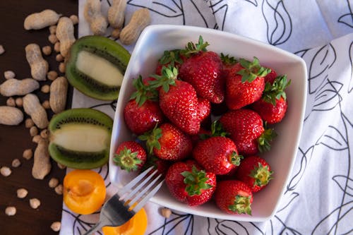 A White Ceramic Bowl Full of Strawberries 