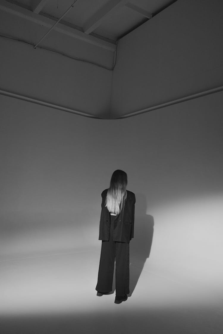 Black And White Abstract Photo Of Woman In Standing Room Corner