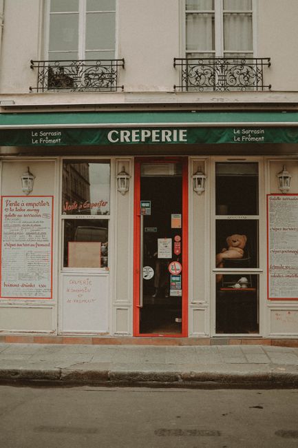 Front view of a traditional Parisian creperie, showcasing classic facade details.