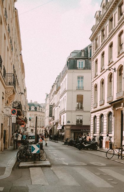 A bustling Paris street with historic architecture and lively atmosphere.