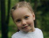Close-Up Shot of a Little Girl with Blue Eyes