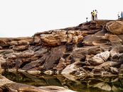 People Standing on Brown Cliff