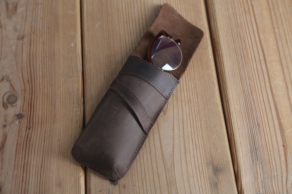 Eyeglasses resting beside a protective case