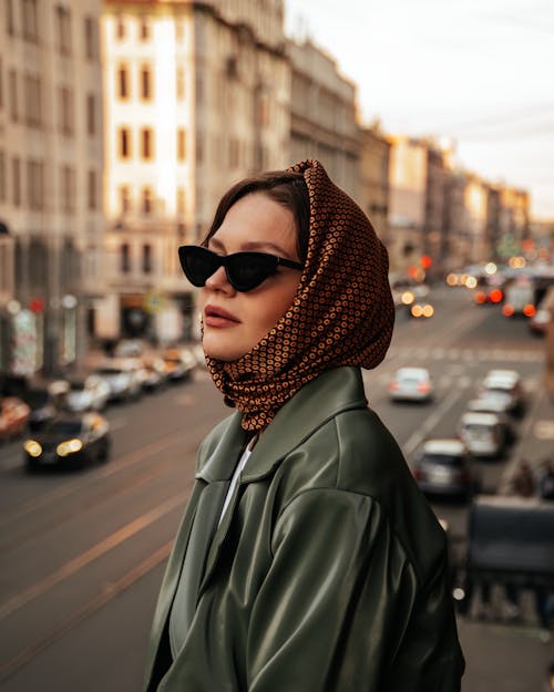 Woman in a Headscarf and Sunglasses Posing in City