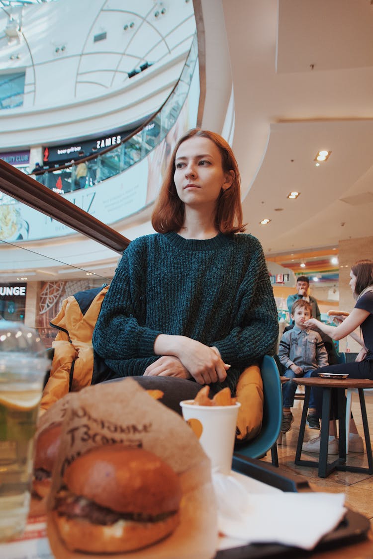 Woman In Sweater Sitting On Chair