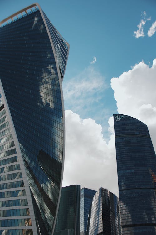 Modern Glass Architecture against the Sky with Clouds