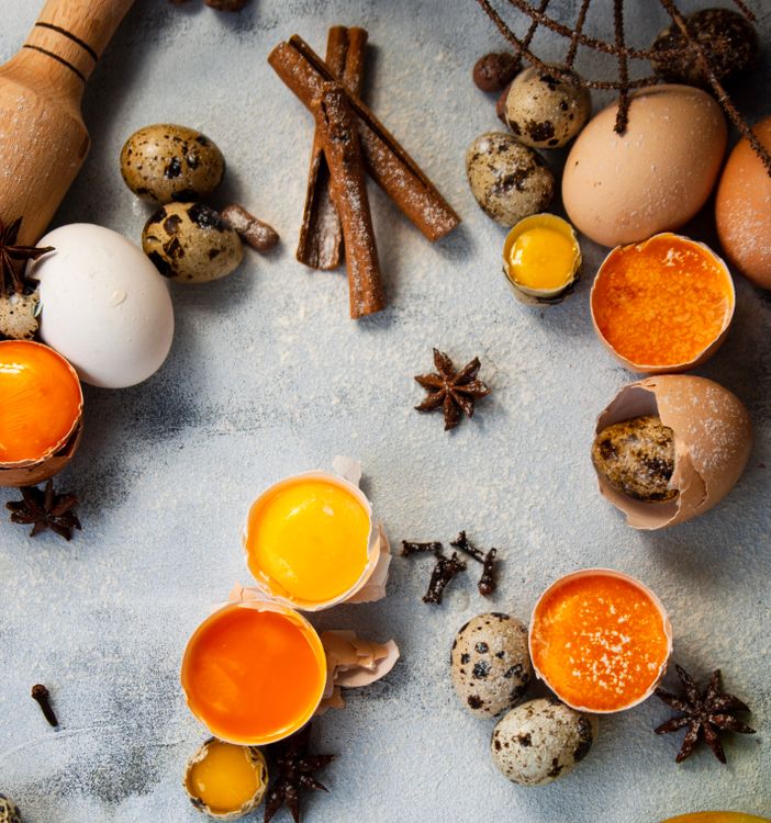 Free An artistic top view composition of baking ingredients including quail eggs, star anise, and cinnamon sticks, perfect for culinary themes. Stock Photo