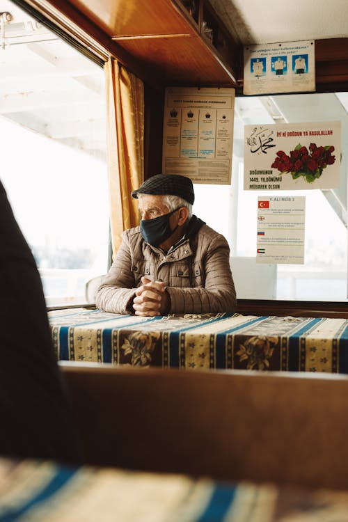 A Man Wearing a Face Mask and Cap