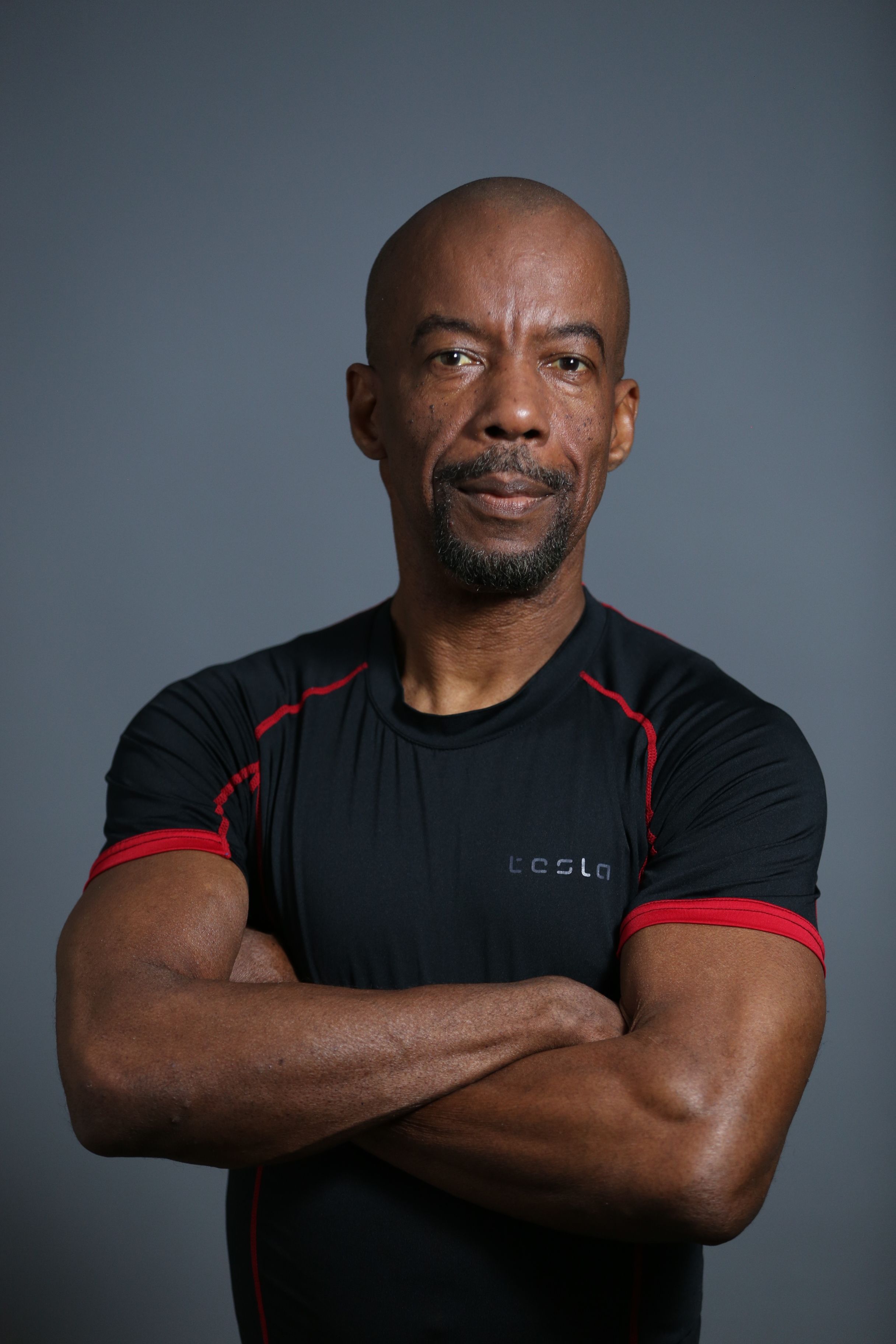 Portrait of a confident man in black sportswear. Perfect for fitness and lifestyle themes.