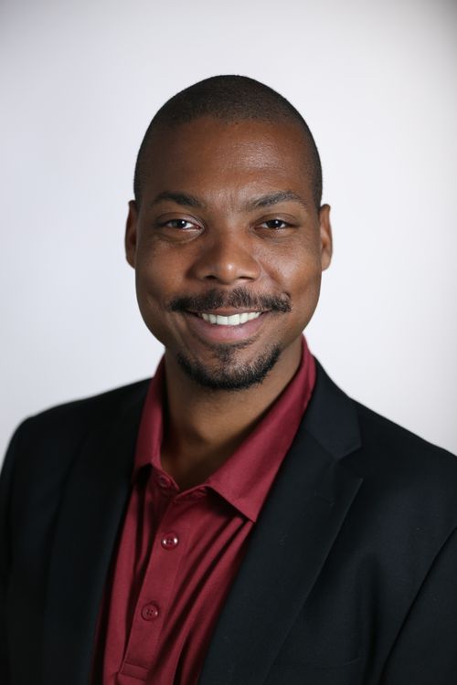 Free Studio portrait of a smiling adult man in formal wear, conveying confidence and approachability. Stock Photo