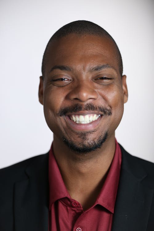 Man Wearing Black Suit on White Background