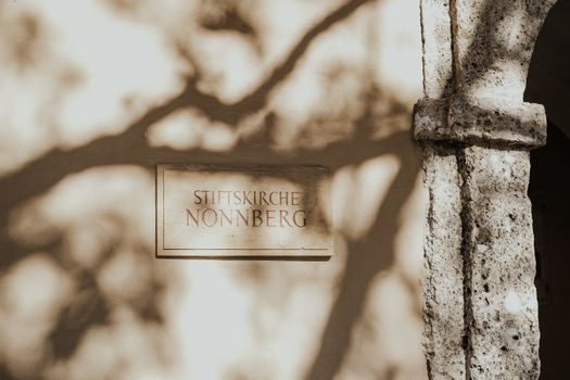 Shadowed sign of Stiftskirche Nonnberg, an iconic abbey in Salzburg, Austria.
