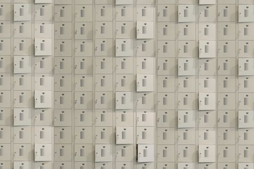 A uniform array of metal storage lockers with some doors slightly ajar, creating a geometric pattern.