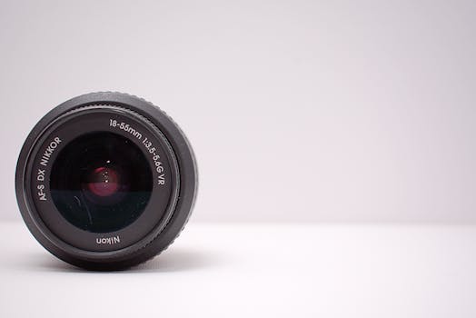 Detailed close-up shot of a Nikon AF-S DX NIKKOR lens on a white background.