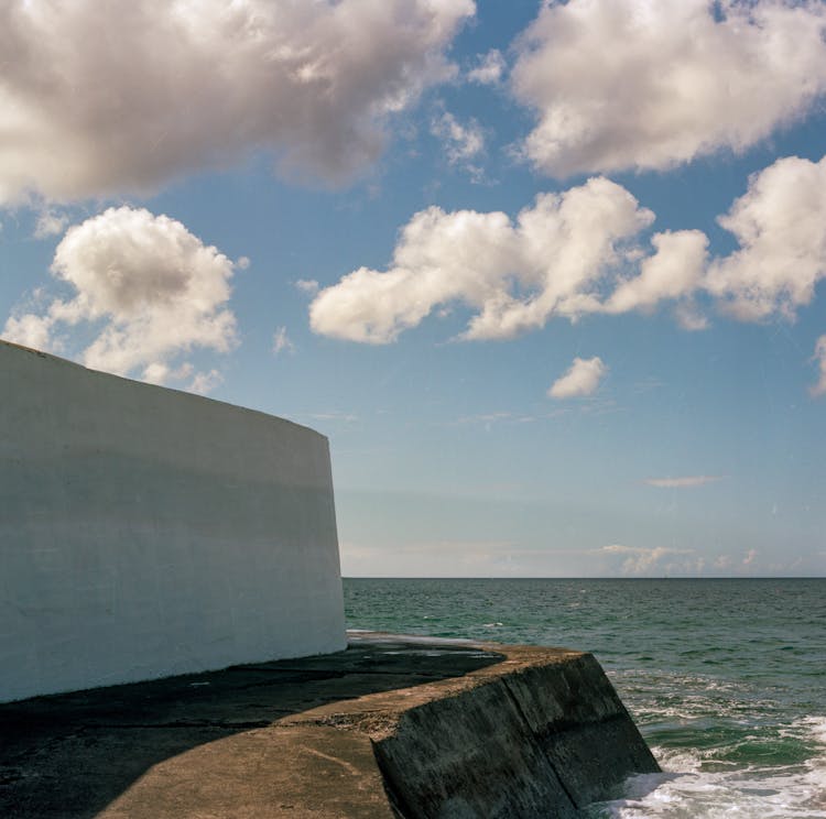 White Concrete Wall Near The Sea