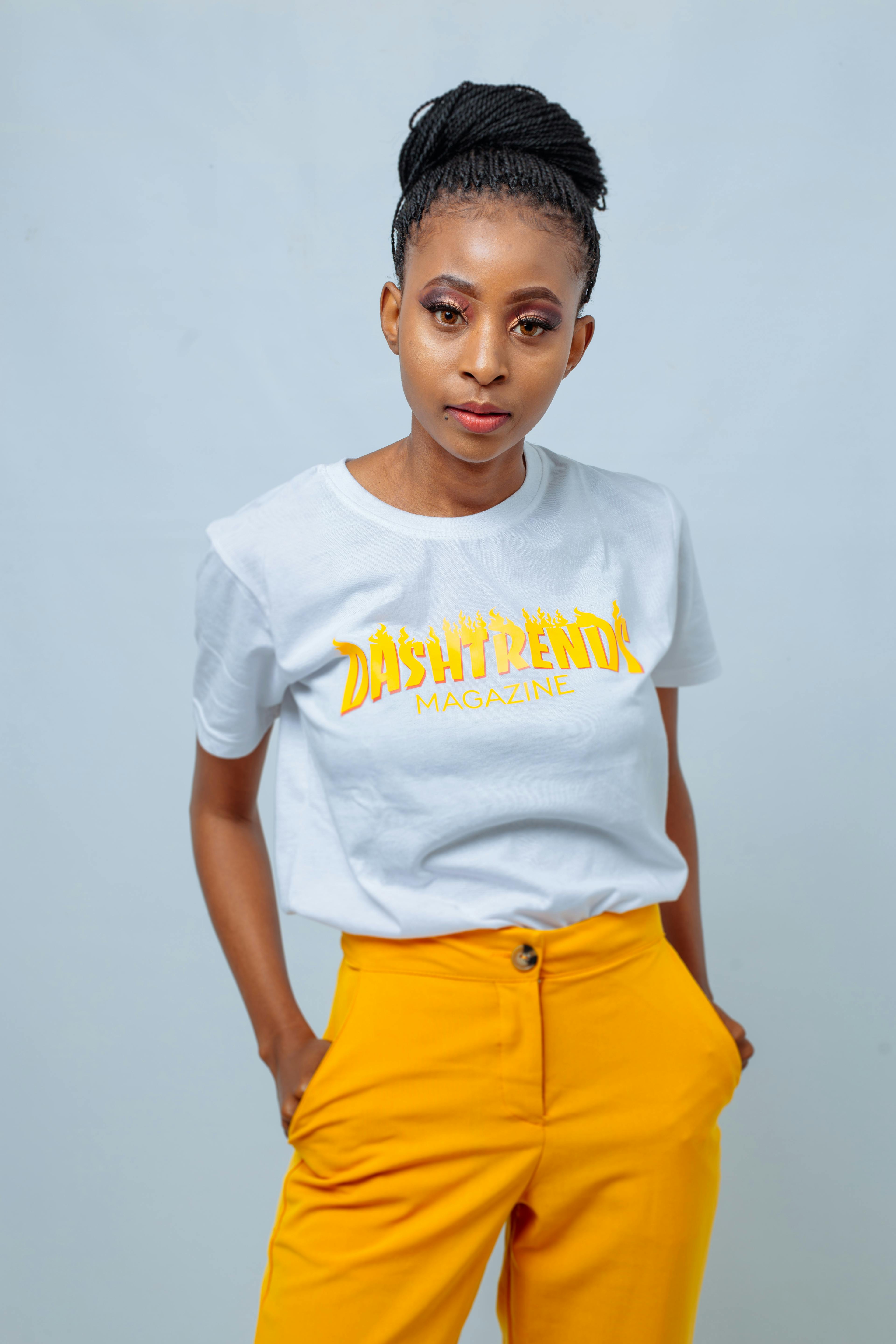 Free Photo | Close-up portrait of a young lovely ginger fellow in a stylish white  shirt and yellow trousers looking at the camera and posing sitting on a bar  chair against a