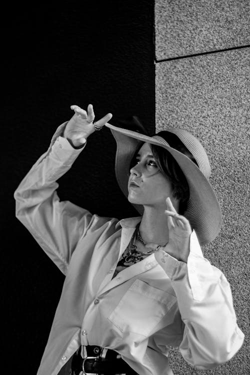 Black and White Photo of a Woman Wearing a Hat