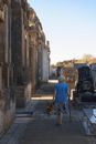 Woman in White Shirt Walking on Sidewalk